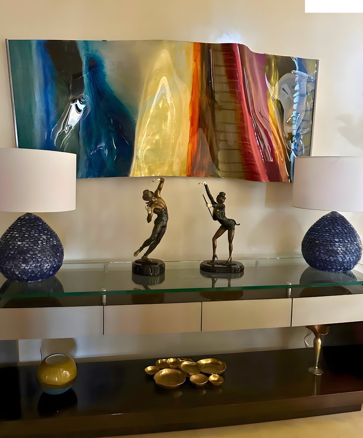 Console wall with glass art and bronze sculptures